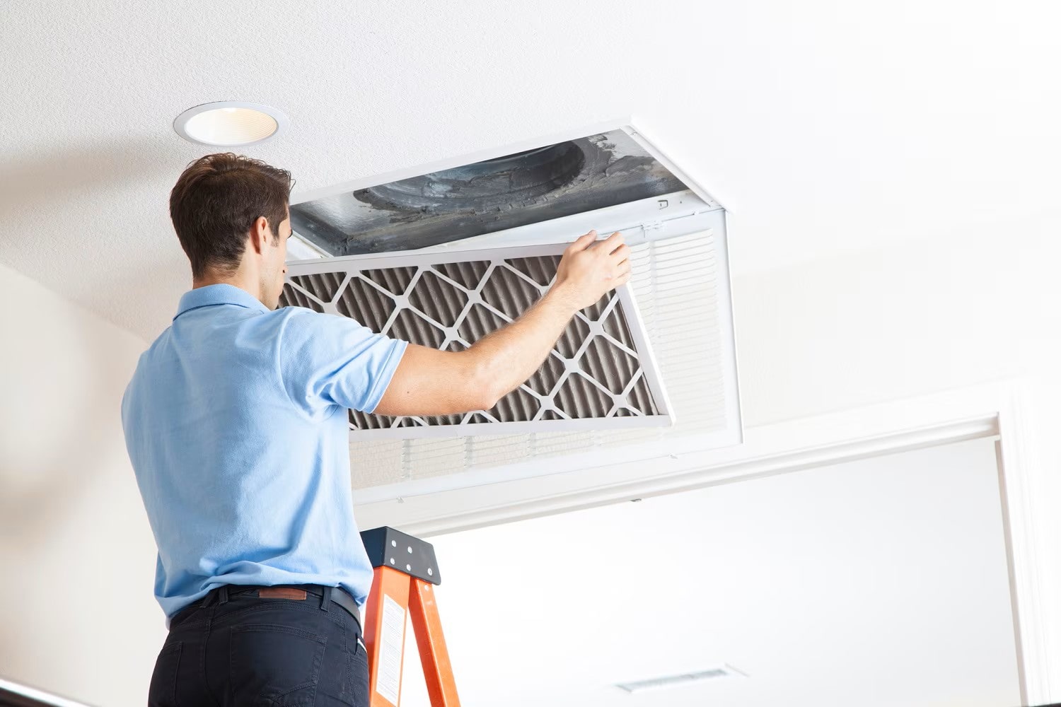 Close-up of a dusty AC vent indicating clogged air ducts