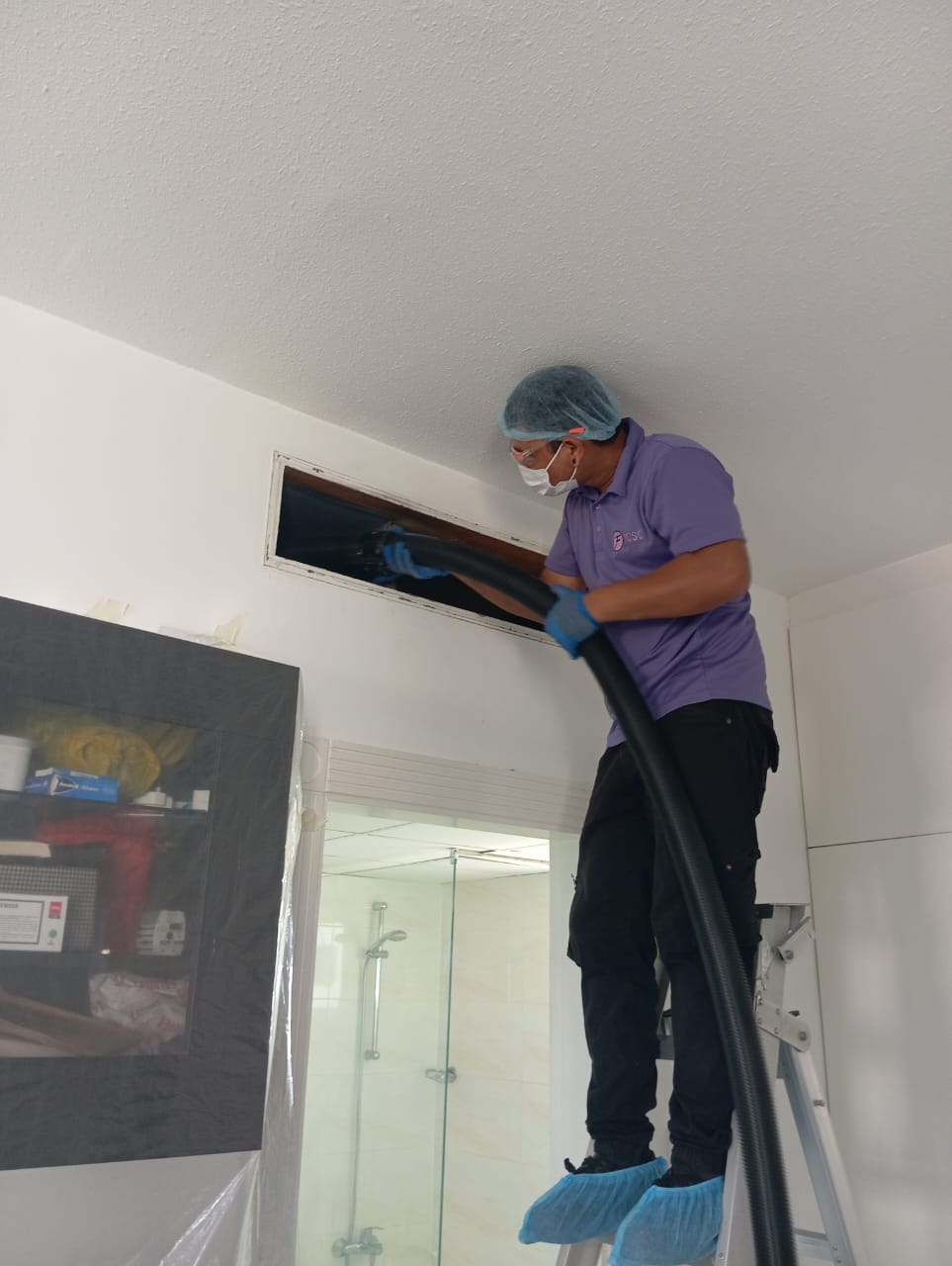 First Clean technician carrying out AC duct cleaning in a Dubai home
